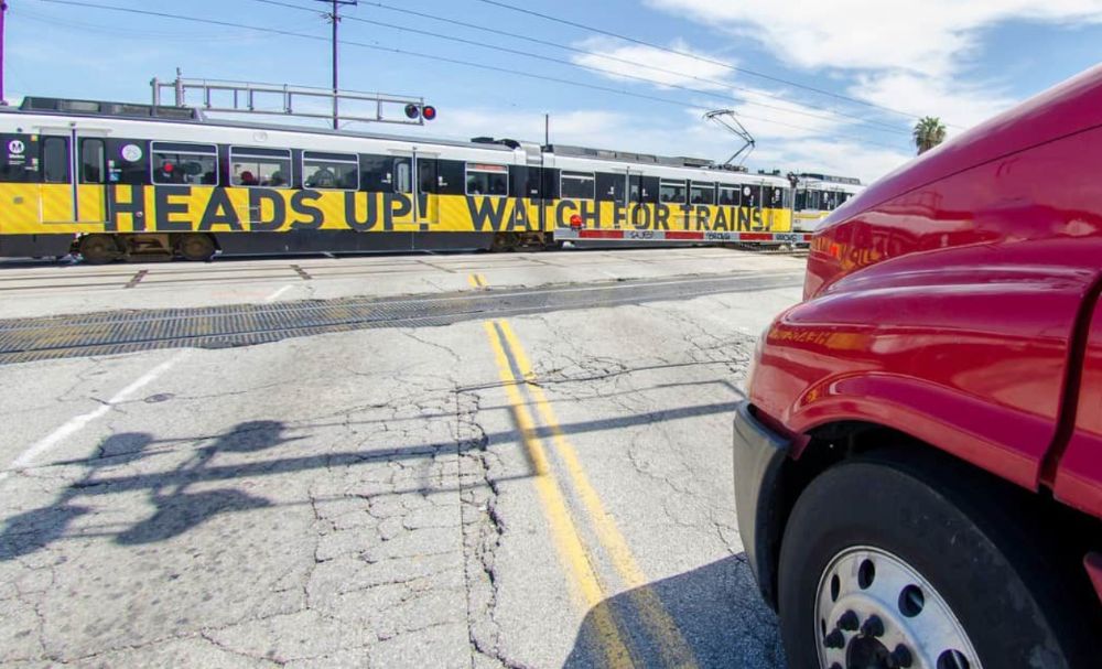 What vehicles must stop at all railroad crossings